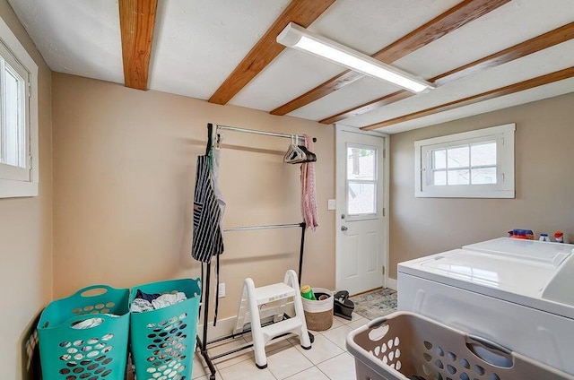 washroom with light tile patterned floors and washer and clothes dryer