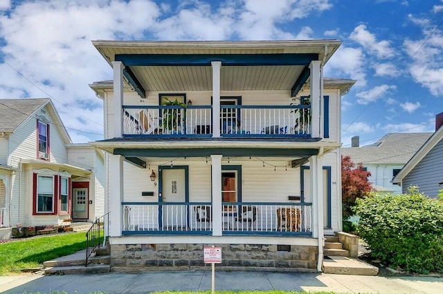 view of front of home with a porch and a balcony