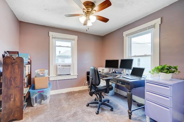 carpeted office featuring cooling unit, ceiling fan, and a textured ceiling