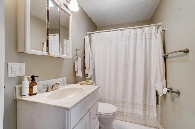 bathroom featuring vanity, a textured ceiling, and toilet