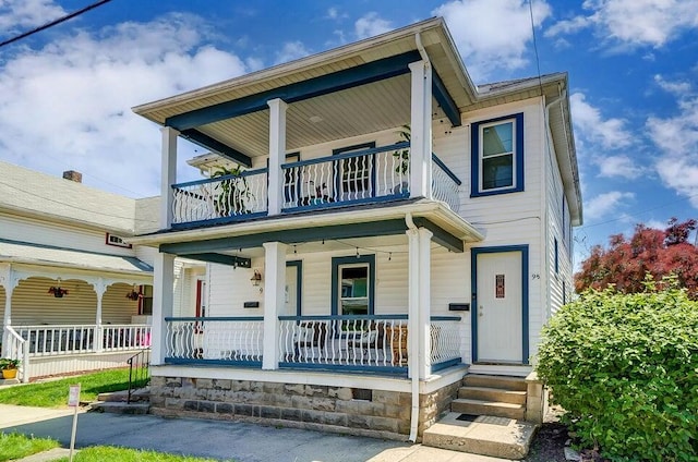 view of front of home featuring a balcony and covered porch