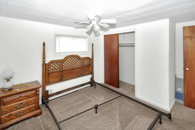 carpeted bedroom featuring a closet, ceiling fan, and baseboards