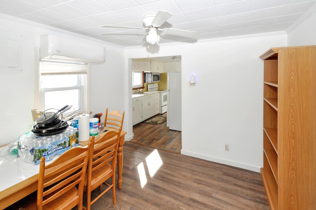 dining area with crown molding, baseboards, ceiling fan, and dark wood-style flooring