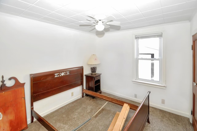 bedroom with ornamental molding, light colored carpet, baseboards, and a ceiling fan