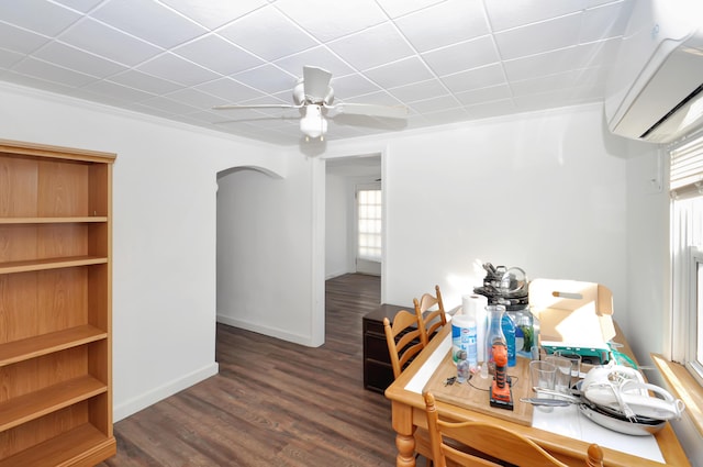 dining room with arched walkways, ceiling fan, baseboards, a wall mounted AC, and dark wood-style floors