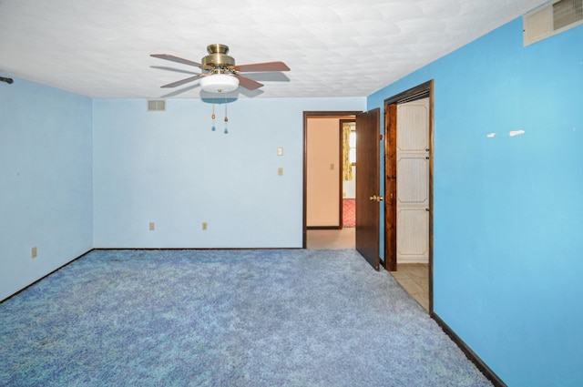 unfurnished room featuring visible vents, ceiling fan, baseboards, and light carpet