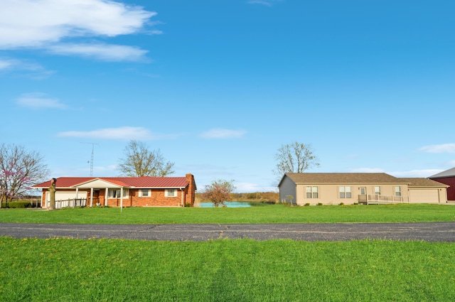 single story home with covered porch and a front lawn
