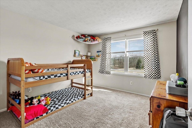 bedroom featuring carpet flooring, a textured ceiling, and baseboards