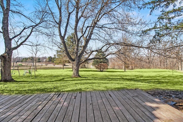 wooden terrace featuring a yard