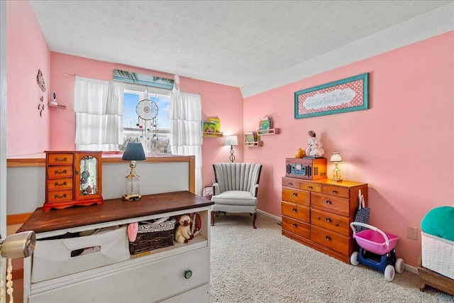 sitting room featuring baseboards, a textured ceiling, and carpet flooring