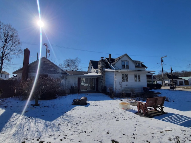 view of snow covered back of property