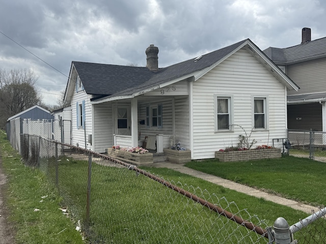 925 Sherman Ave, Springfield, OH 45503 - rear view of property with a chimney, fence private yard, roof with shingles, and a lawn