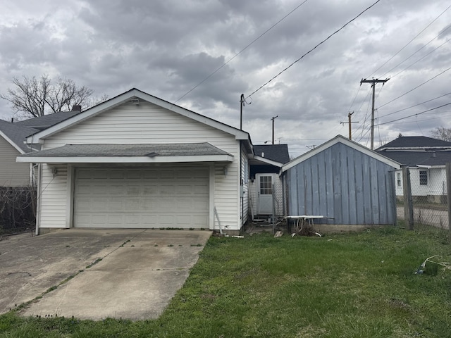 925 Sherman Ave, Springfield, OH 45503 - exterior space featuring fence, an attached garage, a front yard, roof with shingles, and driveway