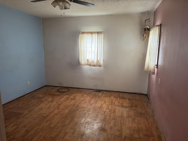 925 Sherman Ave, Springfield, OH 45503 - empty room featuring a textured ceiling, visible vents, wood finished floors, and a ceiling fan