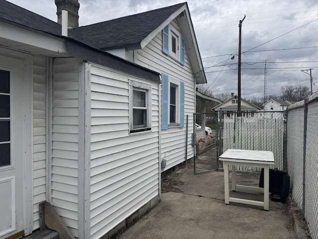 925 Sherman Ave, Springfield, OH 45503 - view of side of home with a shingled roof, fence, and a patio