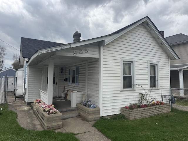 925 Sherman Ave, Springfield, OH 45503 - view of home's exterior featuring covered porch, a gate, and fence