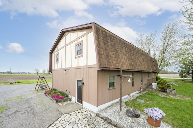 view of home's exterior with a yard and roof with shingles