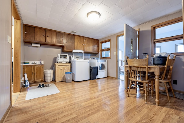 laundry room featuring light wood-style floors, laundry area, and washer and clothes dryer
