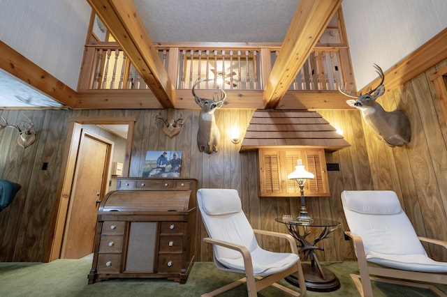 living area featuring wooden walls, carpet floors, and a chandelier