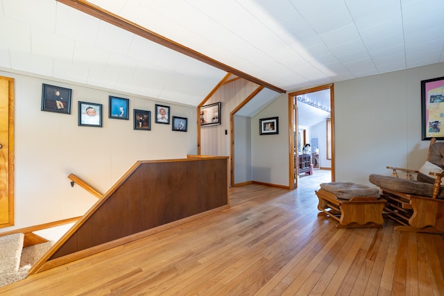 bar with light wood-style flooring and lofted ceiling