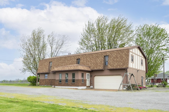dutch colonial featuring a garage, driveway, a shingled roof, and a gambrel roof