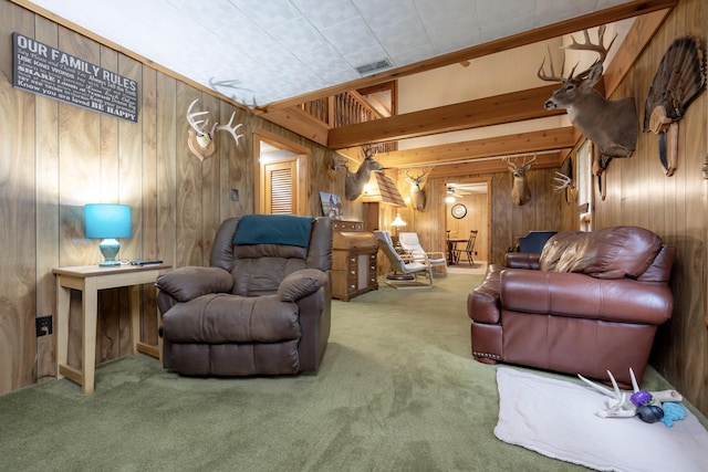 carpeted living area featuring visible vents and wooden walls