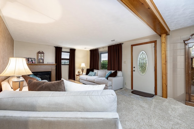 carpeted living area with a glass covered fireplace
