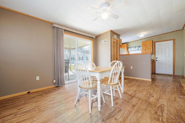 dining room featuring ornamental molding, visible vents, light wood-style flooring, and baseboards