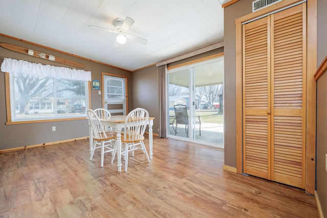 dining area featuring ceiling fan, baseboards, visible vents, and light wood-style floors