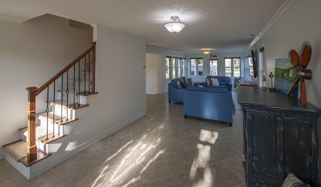 living room with baseboards, visible vents, dark tile patterned flooring, stairway, and ornamental molding