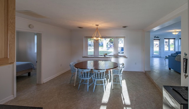 dining room featuring light tile patterned flooring, a notable chandelier, visible vents, baseboards, and ornamental molding