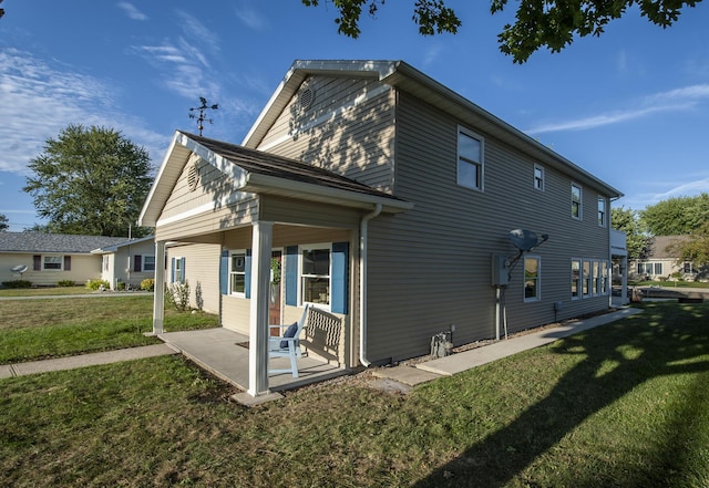 back of property featuring a lawn and a patio area