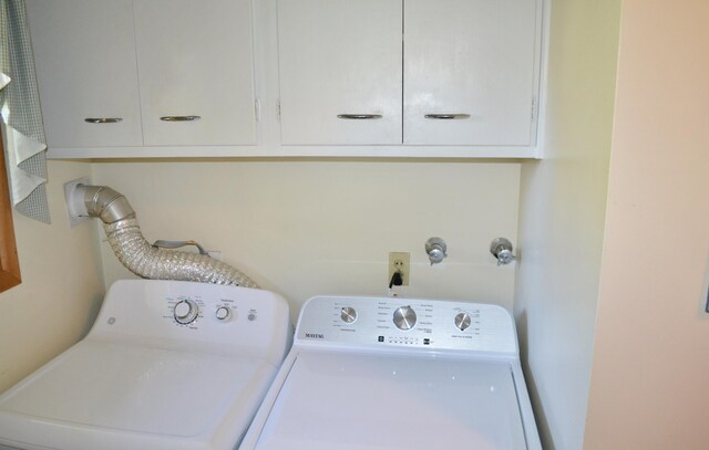 clothes washing area with cabinet space and washing machine and clothes dryer