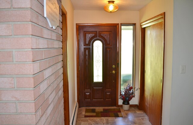 foyer entrance with a baseboard radiator