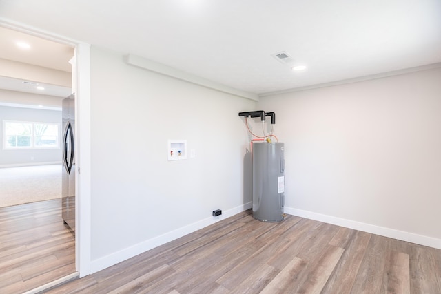 404 N Main St, Jackson Center, OH 45334 - washroom featuring water heater, light wood finished floors, hookup for a washing machine, recessed lighting, and baseboards