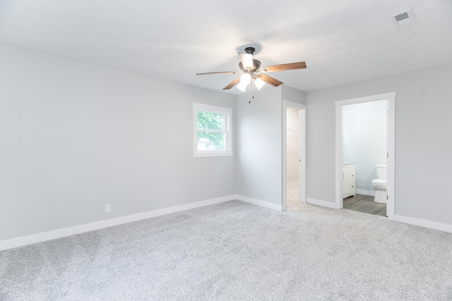 404 N Main St, Jackson Center, OH 45334 - unfurnished bedroom with carpet flooring, baseboards, ensuite bathroom, and ceiling fan
