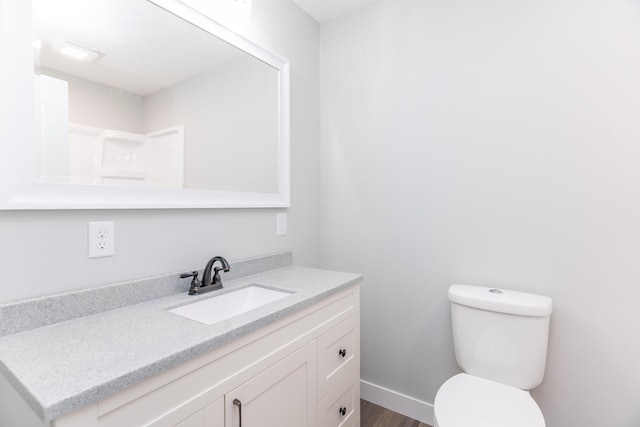 404 N Main St, Jackson Center, OH 45334 - bathroom with toilet, vanity, and wood finished floors