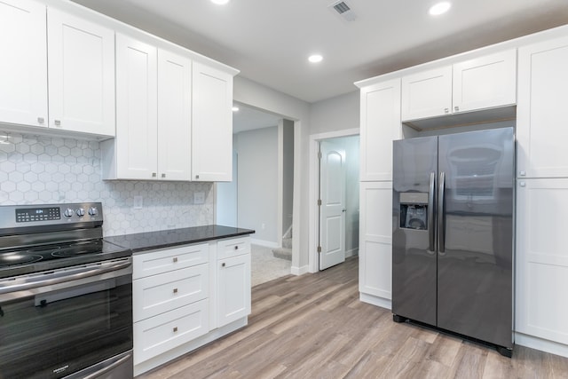 404 N Main St, Jackson Center, OH 45334 - kitchen featuring stainless steel appliances, backsplash, light wood-style floors, white cabinets, and recessed lighting
