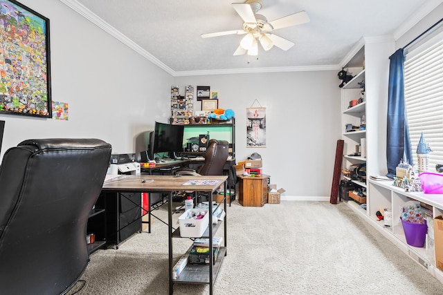 office area featuring a ceiling fan, carpet flooring, crown molding, and baseboards