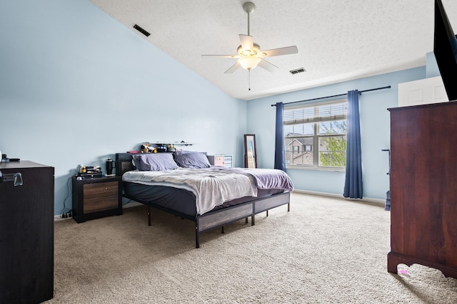 bedroom featuring carpet, visible vents, vaulted ceiling, and a textured ceiling