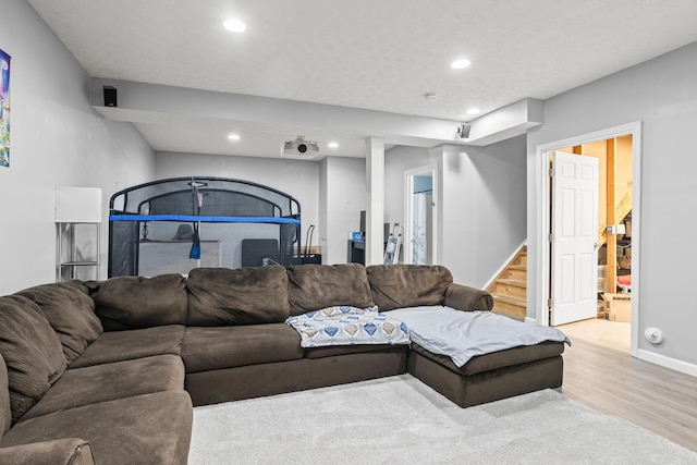 living area with stairway, wood finished floors, recessed lighting, and baseboards