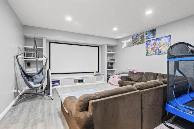home theater featuring wood finished floors, recessed lighting, and baseboards