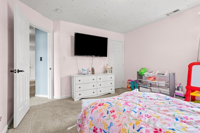 carpeted bedroom with baseboards and visible vents