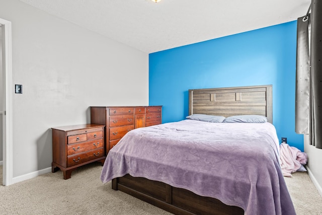 carpeted bedroom with baseboards