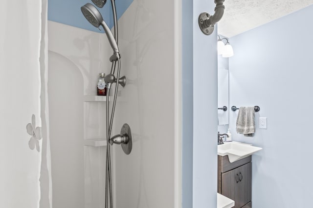 full bath with a shower and vanity