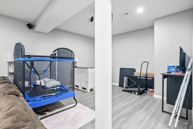 interior space with baseboards, visible vents, and wood finished floors