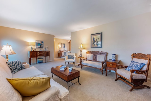 living area featuring carpet floors, baseboards, and an inviting chandelier