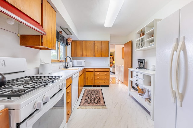 kitchen featuring open shelves, a sink, white appliances, light countertops, and brown cabinetry