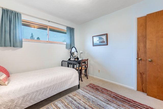 bedroom with carpet flooring and baseboards