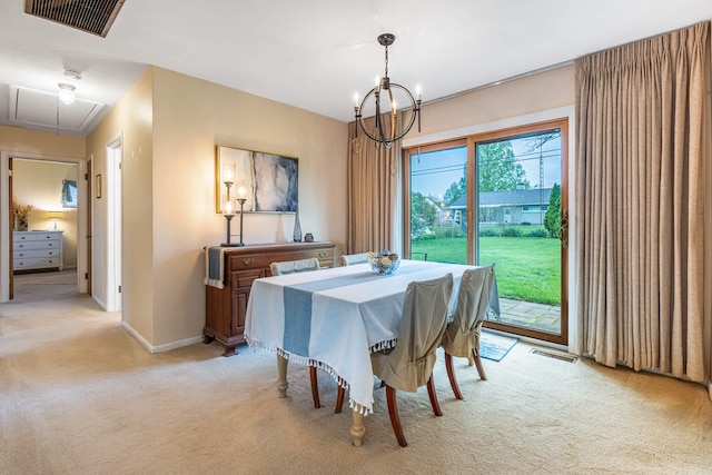 dining space featuring light colored carpet, visible vents, a chandelier, and attic access